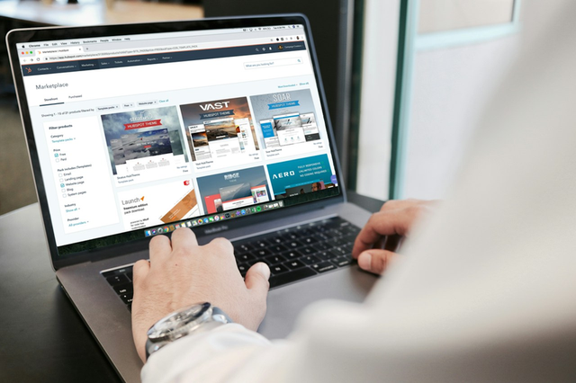 Laptop showing a landing page being reviewed