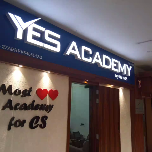 Illuminated Yes Academy signboard at the academy entrance
